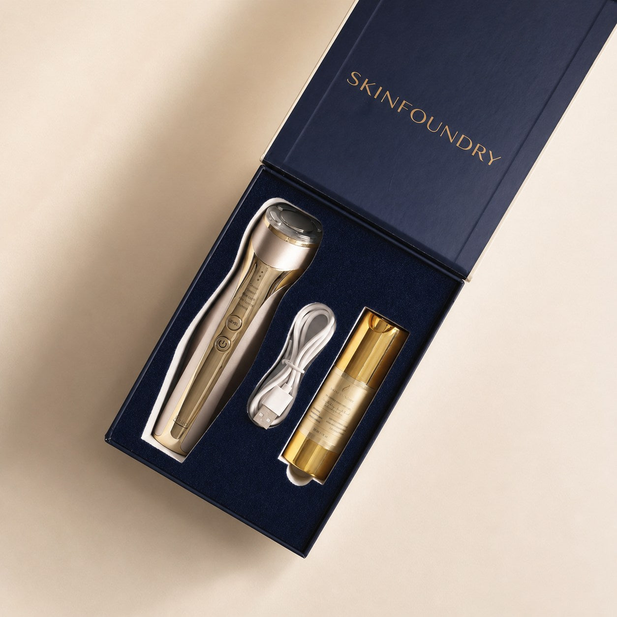 Open SKINFOUNDRY Halo box showing navy interior with Halo device, Lumis starter, and USB-C cable